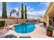 Beautiful backyard pool with lush landscaping, rock waterfall feature, and clear blue water at 21842 E Via De Olivos --, Queen Creek, AZ 85142