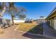 Fenced backyard with desert landscaping, a bench and building at 22102 W Ripple Rd, Buckeye, AZ 85326