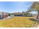 View of a large backyard with grass and the back of the home at 22102 W Ripple Rd, Buckeye, AZ 85326