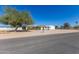 Expansive property with a spacious yard and a single-story home under a clear blue sky at 22102 W Ripple Rd, Buckeye, AZ 85326