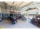 Large garage offering plenty of space for storage and hobbies, with motorcycle and workbench visible at 22102 W Ripple Rd, Buckeye, AZ 85326