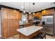Stylish kitchen with stainless steel appliances, custom cabinets, and a granite countertop island at 22102 W Ripple Rd, Buckeye, AZ 85326