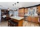 Modern kitchen featuring an island with seating, stainless steel appliances, and a dining area at 22102 W Ripple Rd, Buckeye, AZ 85326
