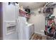 Laundry room with washer, dryer, and shelves for storage at 22102 W Ripple Rd, Buckeye, AZ 85326