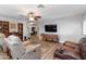 Cozy living room with a TV, recliner, sofa, and access to other rooms in the house at 22102 W Ripple Rd, Buckeye, AZ 85326