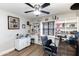 Office featuring built-in bookshelves and cabinets and a ceiling fan at 22102 W Ripple Rd, Buckeye, AZ 85326