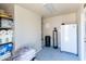 Utility room with shelving, water softener system, and a compact refrigerator for extra storage space at 22102 W Ripple Rd, Buckeye, AZ 85326