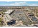 Parking and businesses in the aerial shot showing a parking area surrounded by palm trees and shops under a bright blue sky at 2770 W Kent Dr, Chandler, AZ 85224