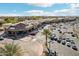 Overhead shot of parking and businesses showing shops and desert landscape with light blue sky and clouds at 2770 W Kent Dr, Chandler, AZ 85224