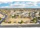 Expansive aerial view of property with open green space, roads, parking, and a light blue sky with clouds at 2770 W Kent Dr, Chandler, AZ 85224