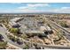Overhead view showing parking, nearby roads, shopping strips and desert landscape under a bright sky at 2770 W Kent Dr, Chandler, AZ 85224