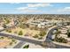 Wide aerial shot of a building surrounded by roads, parking, houses, and a blue sky with clouds at 2770 W Kent Dr, Chandler, AZ 85224