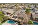 Aerial view displays a backyard oasis with a sparkling pool, patio area, mature trees, and privacy fencing at 2770 W Kent Dr, Chandler, AZ 85224