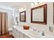 A well-lit bathroom with a double sink vanity and tiled floors at 2770 W Kent Dr, Chandler, AZ 85224