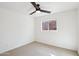 Bedroom with neutral carpet, ceiling fan, and a window providing natural light at 2770 W Kent Dr, Chandler, AZ 85224