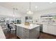 Open kitchen with stainless steel appliances, a central island, and dark hardwood floors at 2770 W Kent Dr, Chandler, AZ 85224