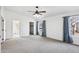 Spacious main bedroom features a ceiling fan, carpeted floors, and a bright window with natural light at 2770 W Kent Dr, Chandler, AZ 85224
