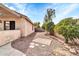 Gravel-covered side yard featuring desert plants and small stone patio at 3060 W Roberta Dr, Phoenix, AZ 85083