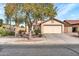 Inviting single-Gathering home featuring a two car garage, desert landscaping, and mature shade tree in the front yard at 3060 W Roberta Dr, Phoenix, AZ 85083