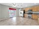 Eat in kitchen featuring stainless steel appliances, tile floors, and a sliding glass door at 3060 W Roberta Dr, Phoenix, AZ 85083