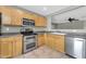 Kitchen featuring tile flooring, stainless steel appliances, and light maple cabinets at 3060 W Roberta Dr, Phoenix, AZ 85083