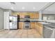 Kitchen showcasing stainless steel appliances, tile flooring, and light maple cabinets at 3060 W Roberta Dr, Phoenix, AZ 85083