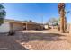 Backyard featuring a brick patio, gravel landscaping, and fenced perimeter at 3238 E Cholla St, Phoenix, AZ 85028