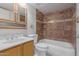 Well-lit bathroom featuring a tiled shower over tub, neutral walls, and vanity with storage at 3238 E Cholla St, Phoenix, AZ 85028