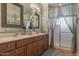 Double vanity bathroom with stone countertops and framed mirrors, with a shower at 33550 N Dove Lakes Dr # 2030, Cave Creek, AZ 85331