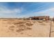 Expansive backyard view showing the home, and RV in the background at 36212 W Hadley St, Tonopah, AZ 85354