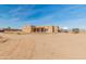 Single story home featuring a desert landscape, clear skies, and a covered back patio at 36212 W Hadley St, Tonopah, AZ 85354