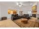 Bright living room with fireplace and multiple sofas near sliding glass doors at 36212 W Hadley St, Tonopah, AZ 85354