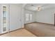 Inviting living room featuring tiled entry, neutral walls, ceiling fan, and window at 36212 W Hadley St, Tonopah, AZ 85354