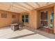 Inviting covered patio featuring a modern fire pit and string lights, perfect for outdoor entertaining at 36212 W Hadley St, Tonopah, AZ 85354