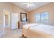 The cozy bedroom features tile floors, a ceiling fan, a window and a closet at 40746 N Boone Ln, Anthem, AZ 85086