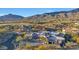 Aerial shot of a desert home with surrounding mountains, showcasing its unique design and expansive outdoor space at 40915 N 107Th Pl, Scottsdale, AZ 85262