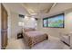 Cozy bedroom with a plush bed, geometric rug, and a window providing natural light at 40915 N 107Th Pl, Scottsdale, AZ 85262