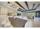Open-concept living and dining area with elegant chandelier, wood beams, and mountain views at 40915 N 107Th Pl, Scottsdale, AZ 85262