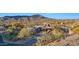 Stunning desert home with stone accents, lush landscaping, and mountain views at 40915 N 107Th Pl, Scottsdale, AZ 85262