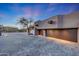 Home's expansive paver driveway leading to a multi-car garage, enhanced by elegant landscaping at 40915 N 107Th Pl, Scottsdale, AZ 85262