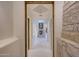 Hallway view of stone fireplace, accent lighting, and open floor plan design at 40915 N 107Th Pl, Scottsdale, AZ 85262