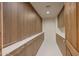 Hallway featuring extensive custom built-in cabinets offering ample storage space with modern hardware at 40915 N 107Th Pl, Scottsdale, AZ 85262