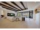 Spacious living room boasts stone fireplace, wood beams, and large windows with stunning views at 40915 N 107Th Pl, Scottsdale, AZ 85262