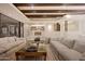 Large, airy living room with beamed ceilings, comfortable seating, and seamless flow into the kitchen area at 40915 N 107Th Pl, Scottsdale, AZ 85262