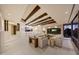Bright, open living room features beamed ceilings, a stone fireplace, and a comfortable seating area at 40915 N 107Th Pl, Scottsdale, AZ 85262