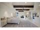 Serene main bedroom with stone fireplace, ceiling beams, and elegant furnishings at 40915 N 107Th Pl, Scottsdale, AZ 85262