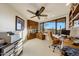 Well-lit office with built-in wood cabinets, large window with desert views, and a spacious workstation at 40915 N 107Th Pl, Scottsdale, AZ 85262