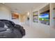 Sitting area featuring a massage chair, stone fireplace, and built-in entertainment center at 40915 N 107Th Pl, Scottsdale, AZ 85262