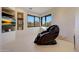 Relaxing sitting area with a massage chair, scenic views, and built-in shelves at 40915 N 107Th Pl, Scottsdale, AZ 85262