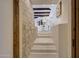 Contemporary staircase with built-in lights, stone accent wall, and open concept living area at 40915 N 107Th Pl, Scottsdale, AZ 85262